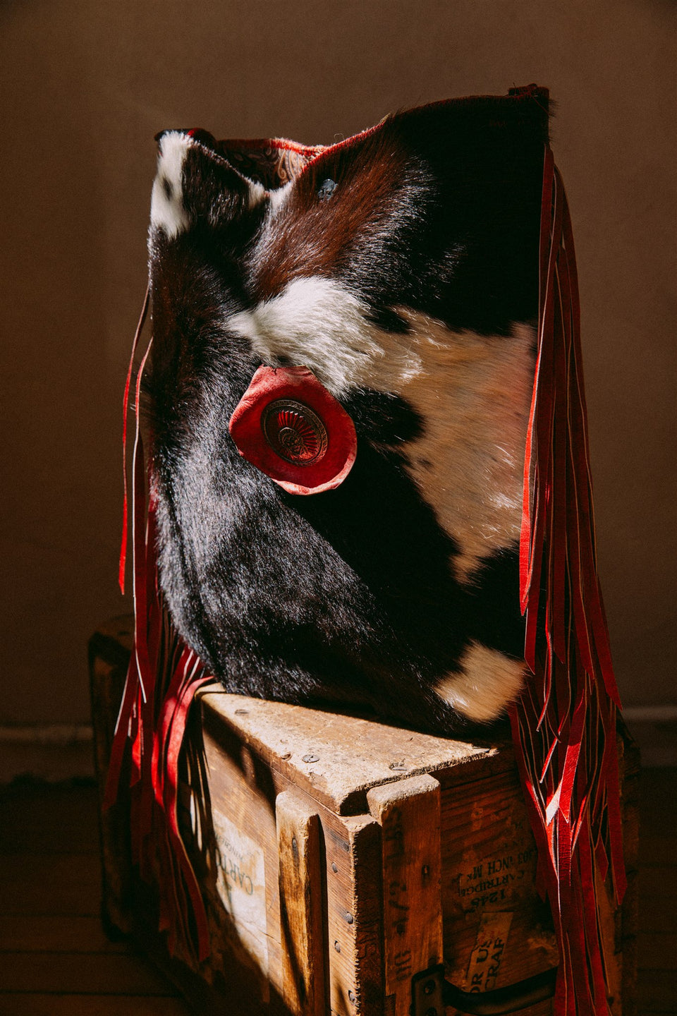 Vintage leather cow hide and red fringe bag