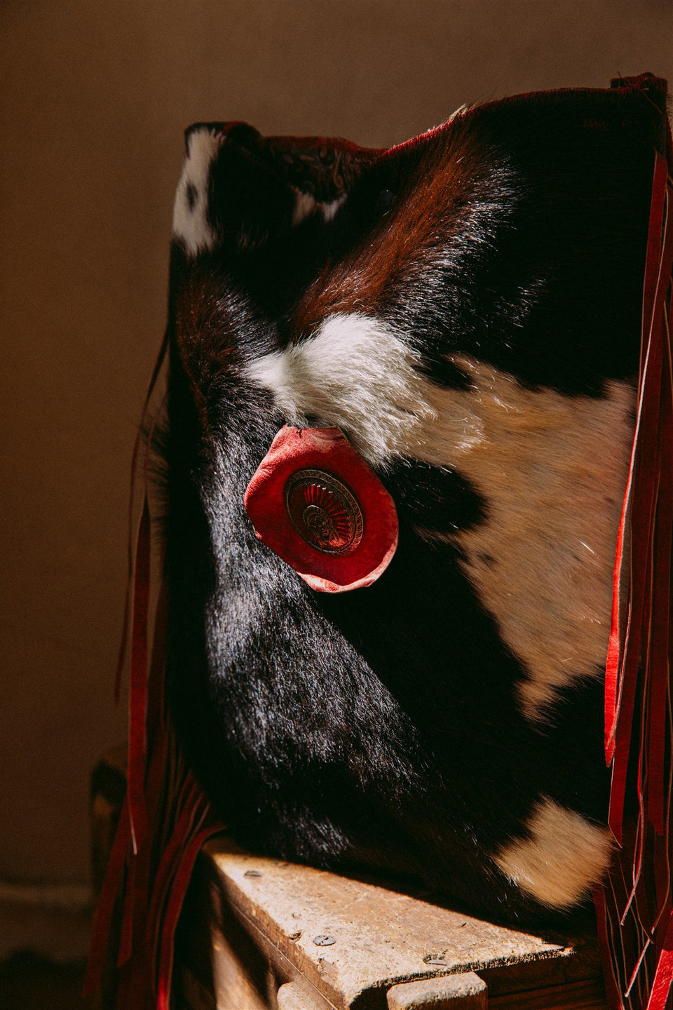 Vintage leather cow hide and red fringe bag