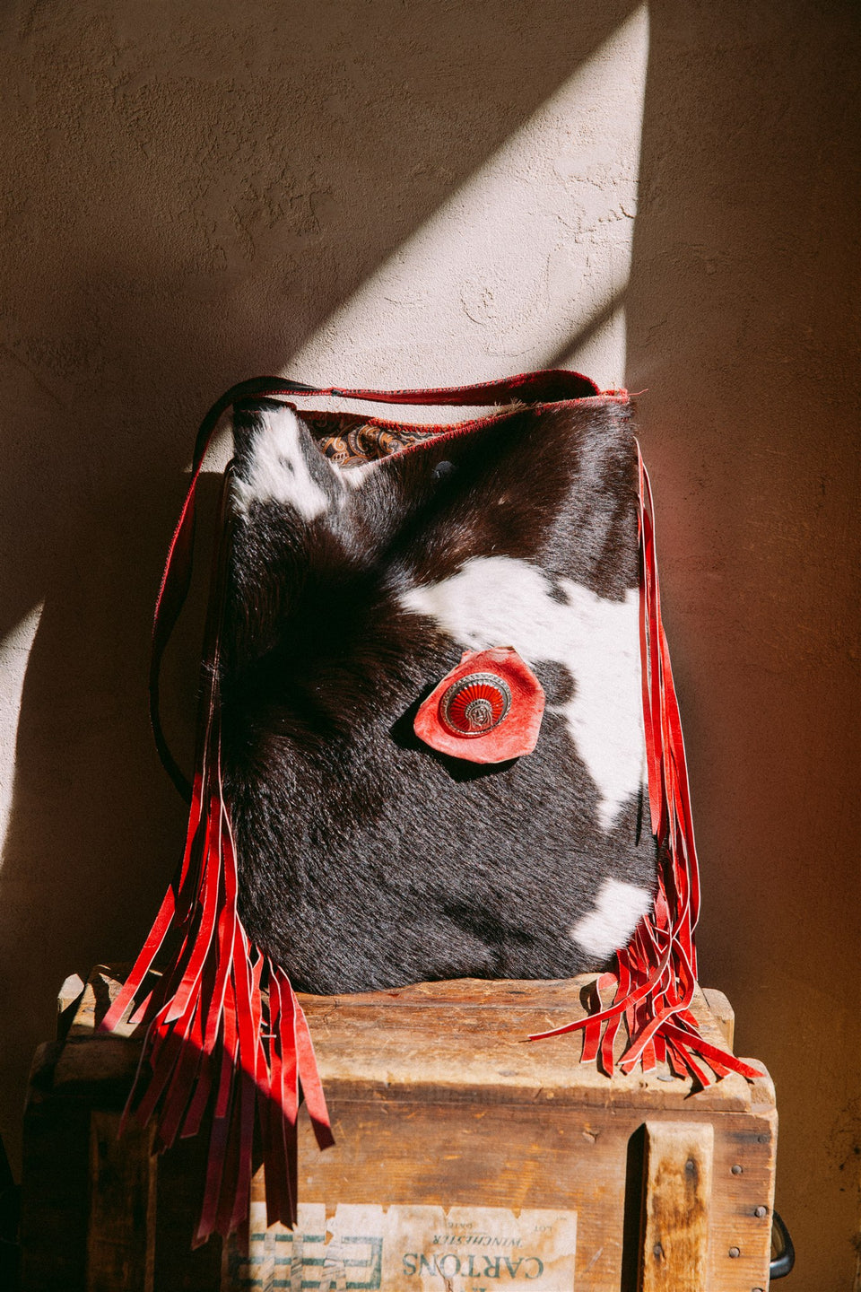 Vintage leather cow hide and red fringe bag