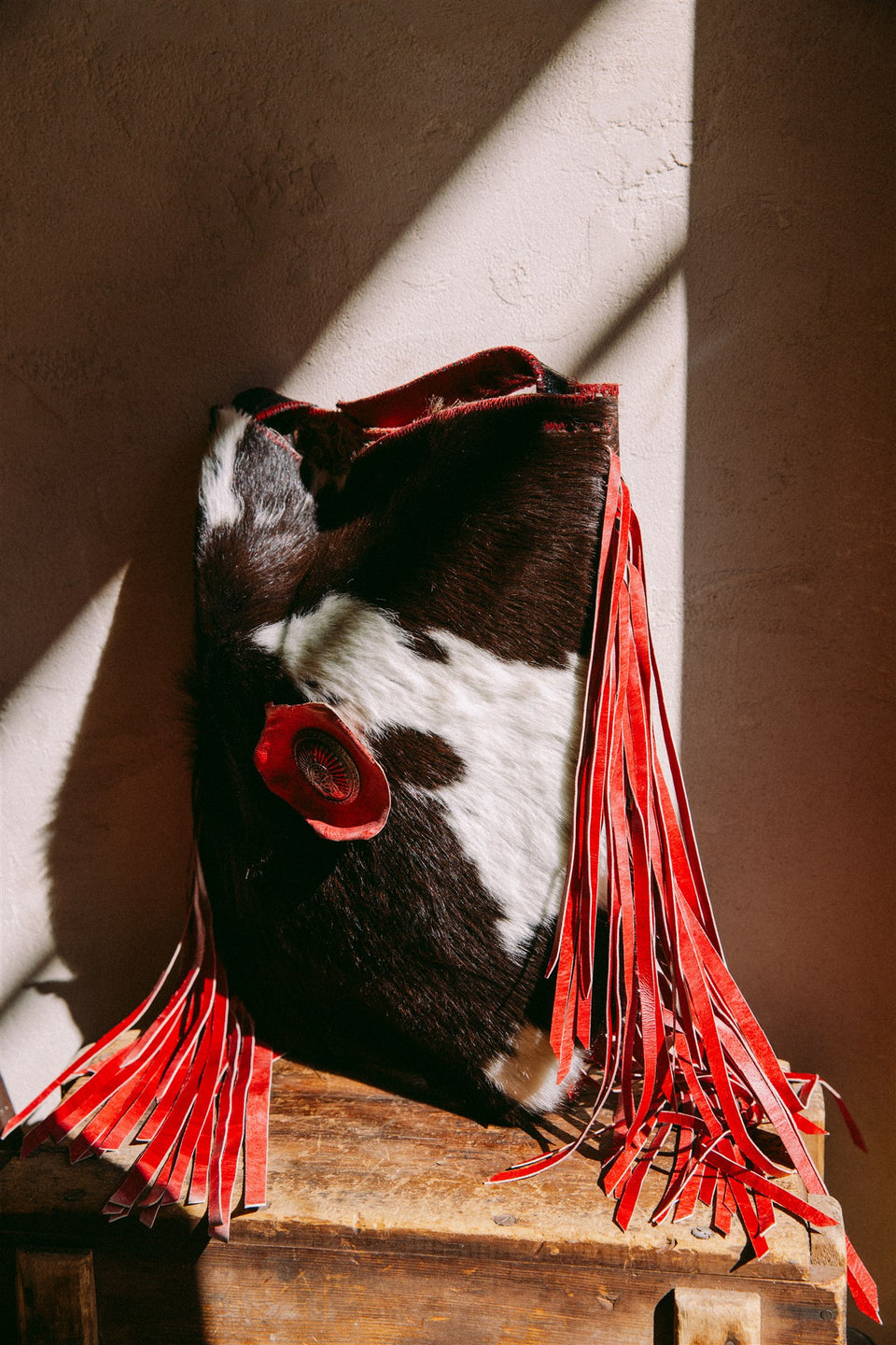 Vintage leather cow hide and red fringe bag