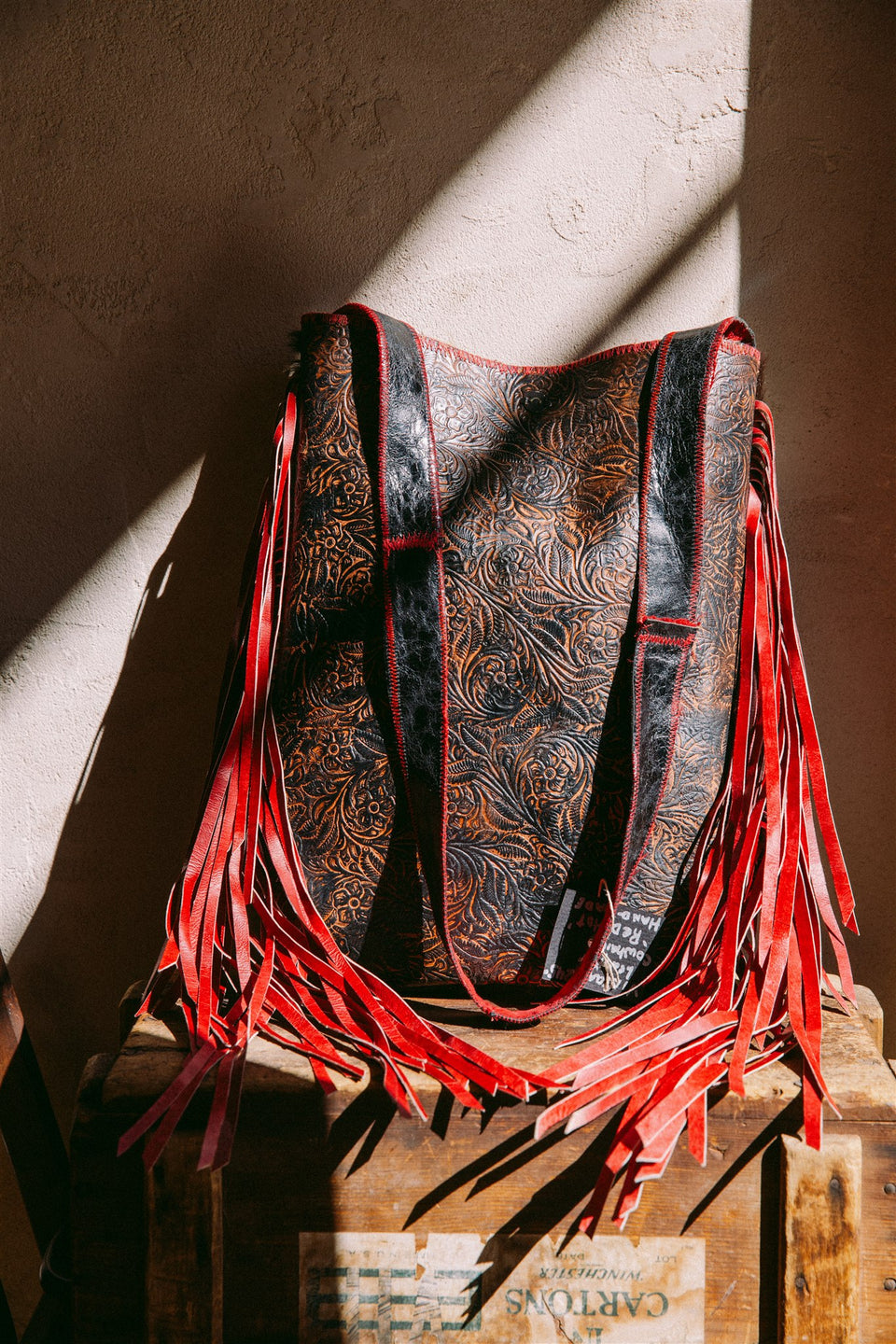 Vintage leather cow hide and red fringe bag