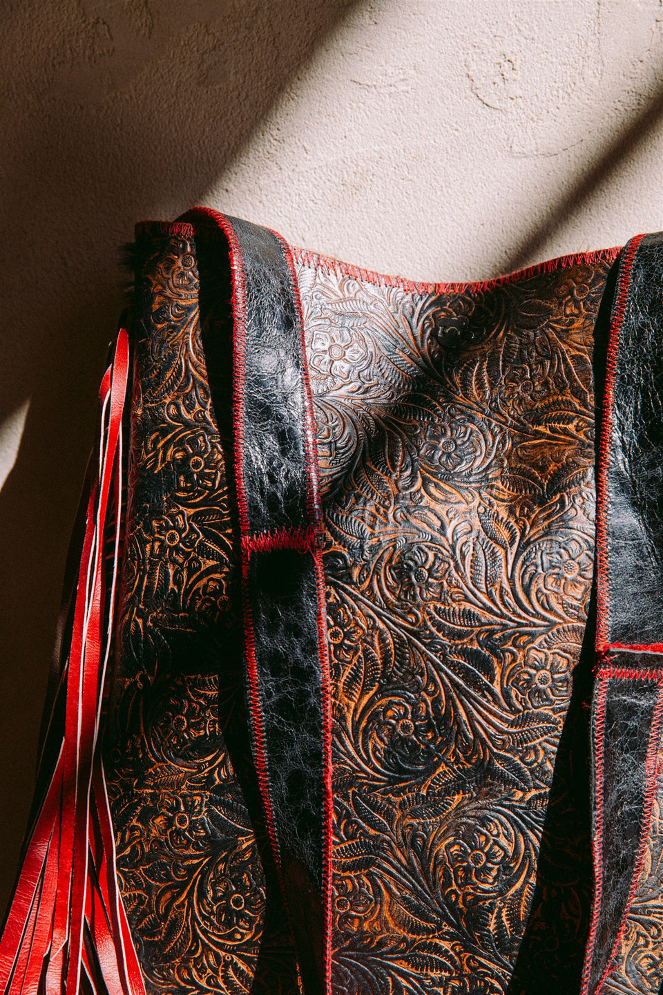 Vintage leather cow hide and red fringe bag