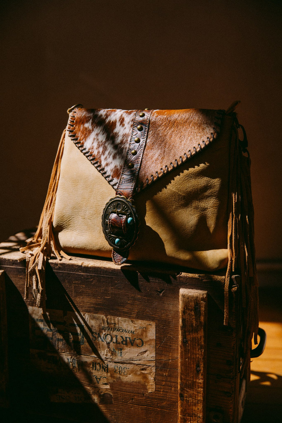 Leather cow hide purse with fringe and buckle
