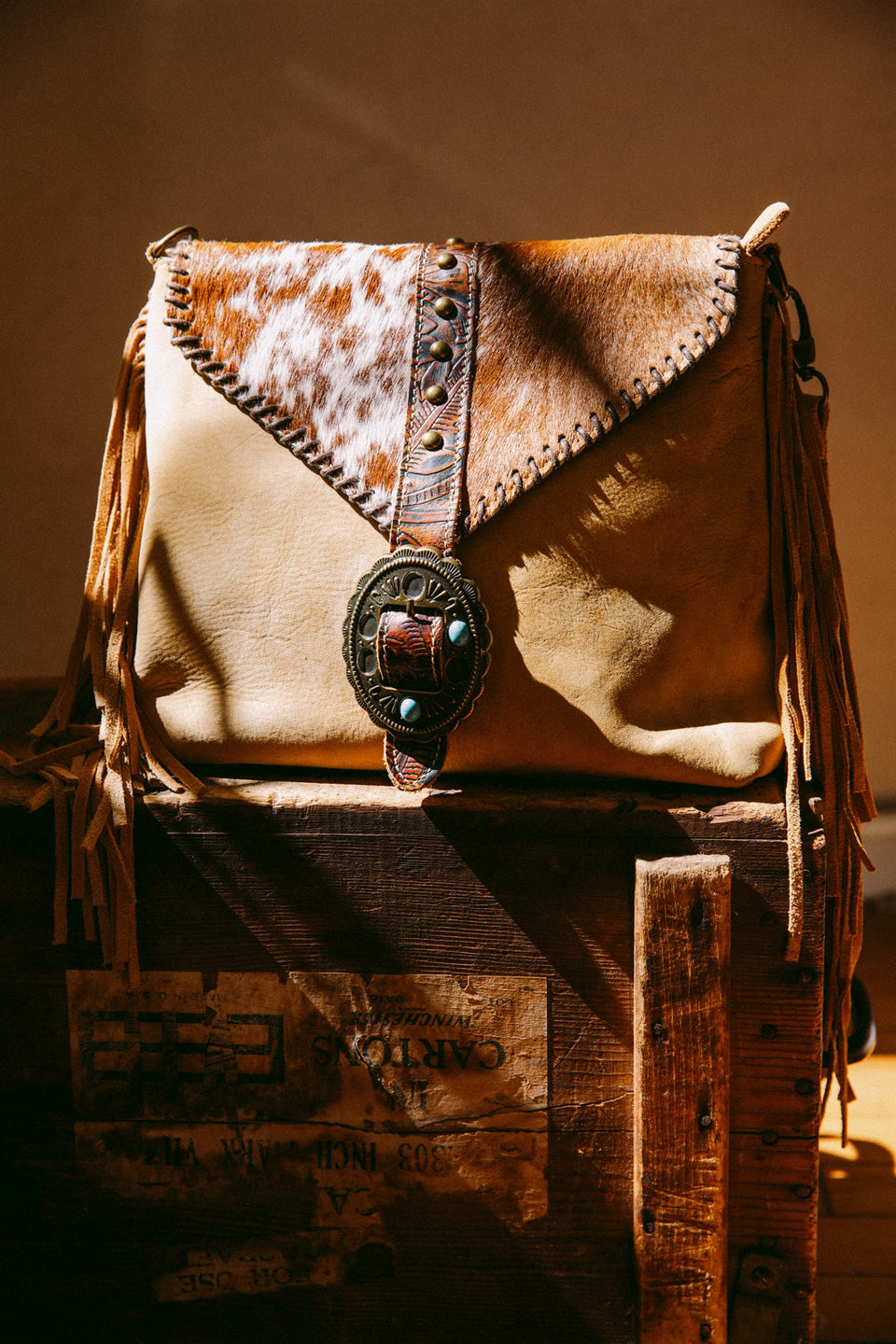 Leather cow hide purse with fringe and buckle