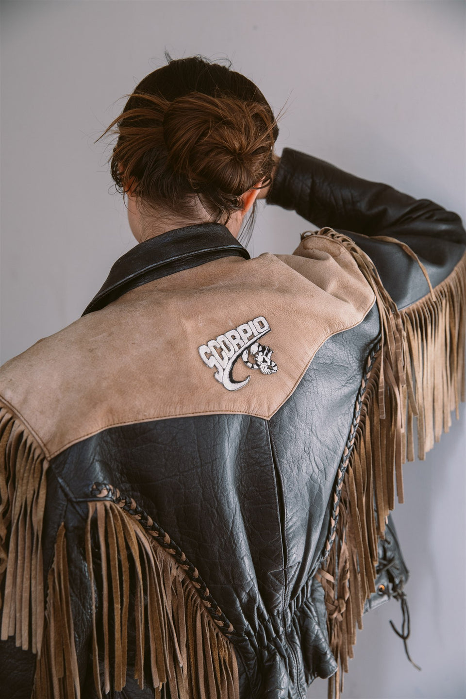 Fringe black and brown leather jacket with "Jesus" and "Scorpio" patches
